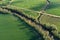 Beautiful spring time farmland landscape with river and gravel road, aerial