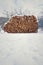 Beautiful stack of chopped firewood in snowy country, sunny winter