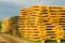 Beautiful stacked pile of peeled logs for log house construction