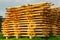 Beautiful stacked pile of peeled logs for log house construction