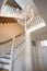 Beautiful staircase in victorian style with crystal chandelier and decorative railing