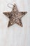 Beautiful star of birch bark on wooden craftsman background light. Ready for Christmas greeting