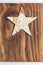 Beautiful star of birch bark on wooden craftsman background. Ready for Christmas greeting