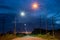 A beautiful starlight landscape view of orange and white lanterns beside a country road