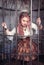 Beautiful steampunk woman in the cage