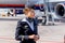 Beautiful stewardess dressed in official dark blue uniform of Aeroflot Airlines on airfield. Passenger jet aircraft on background.