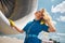 Beautiful stewardess standing by airplane at in airfield