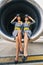 Beautiful stewardesses in uniforms sitting cross-legged inside the turbofan engine