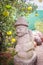 Beautiful stone idol in the orange farm for tourist take a selfie with him at Jeju Island, South Korea.