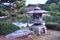 Beautiful stone lantern and cedar tree in traditional japanese garden in Tokyo. Relax, tranquility and meditation.