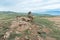 Beautiful stone outlier or rock formation against the background of mountains and Baikal lake. Summer mountain landscape.