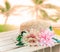 Beautiful straw hat decorated with artifucial flowers on wood ta