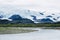 Beautiful stream in Katmai National Park in Alaska. Giant glaciers on the mountains in the background