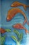 Beautiful street art picture showing red fishes and green sea grass on blue background. Willemstad.