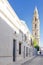 Beautiful Street in Estepa province of Seville with Tower of Victory in the background. Charming white village in Andalusia