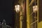 Beautiful street lanterns illuminated at night on wall of house