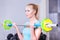 Beautiful strong blond woman with barbell