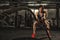 Beautiful strong sporty woman doing crossfit exercise with battle ropes