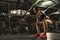 Beautiful strong sporty woman doing crossfit exercise with battle ropes