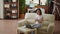 Beautiful student sitting on couch inside modern and cozy apartment