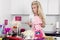 Beautiful stunning funny blonde woman dressed in costume cook cooks in the kitchen