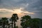 Beautiful stunning scenic panoramic view of the golden sky and reflections on the Andaman sea with palm trees during the sunset at