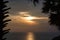 Beautiful stunning scenic panoramic view of the golden sky and reflections on the Andaman sea with palm trees during the sunset at