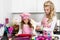 Beautiful stunning woman mother and daughter in aprons kitchen cooking in the kitchen cookies