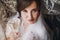 Beautiful stylish brunette bride in silk robe and veil cheering with glass of champagne in the morning at window. Sensual portrait