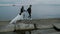 Beautiful stylish couple bride and groom walking along the embankment at dusk, slow motion