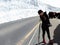 Beautiful and stylish female model in a fashion winter outfit posing for a photo in the famous snow corridor in the japanese alps