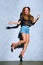 beautiful stylish mulatto girl jumping and looking