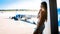 Beautiful stylish young woman talking by phone in airport and looking on airplanes on runway