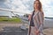 Beautiful successful caucasian young lady wearing stylish  suit in private aircraft. Business, success, travel concept