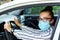 Beautiful successful smiling rich business woman in white suit sitting in gray car salon , wearing glasses talking on