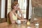 Beautiful successful woman working at coffee shop with laptop computer enjoying coffee cup