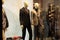 Beautiful suits on mannequins in showcases of fashion store