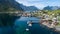 Beautiful summer aerial view of Reine, Norway, Lofoten Islands, with skyline, mountains, famous fishing village with red fishing c