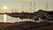 On a beautiful summer evening, the sun sets over the docked boats at the wharf of Summerside, PEI.