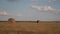 Beautiful Summer Farm Scenery with Haystacks. Field Landscape with Rolls and Sky. Agriculture Concept.