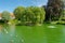 Beautiful summer garden with a birds pond with green water