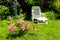 Beautiful summer garden with a white deckchair