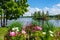 Beautiful summer landscape on lake and with flowers on foreground