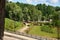 Beautiful summer landscape. This is a park area with bike paths, trees, flowers and lawns on the lake