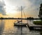 Beautiful summer landscape of Trakai lake and little sport yacht. Lake and sunset sky.