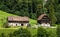 A beautiful summer landscape with two nice houses, located at the foothill of the Alps in Engelberg, Switzerland.