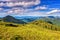 Beautiful summer mountain ridge, bright daytime landscape with green mountains and blue cloudy sky