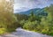 Beautiful summer panoramic landscape. Cypress hills and green mountain slopes. The road going through the thickets of subtropical