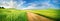 Beautiful summer rural natural landscape with fields young wheat, blue sky with clouds.