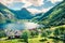 Beautiful summer scene of Geiranger port, western Norway. Sunny view of Sunnylvsfjorden fjord. Traveling concept background.